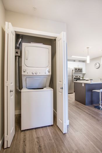 A white dishwasher is open in a kitchen.